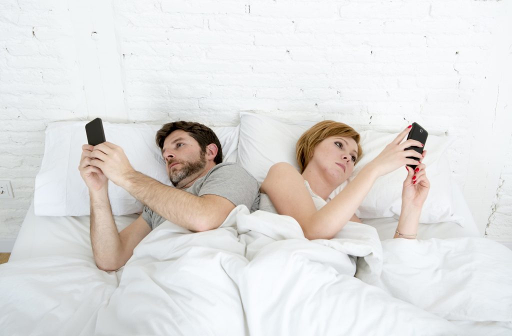 Young-Couple-Using-Mobile-Phon-116425784